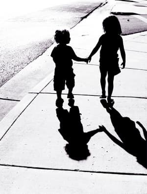 Black and white photograph - children holding hands